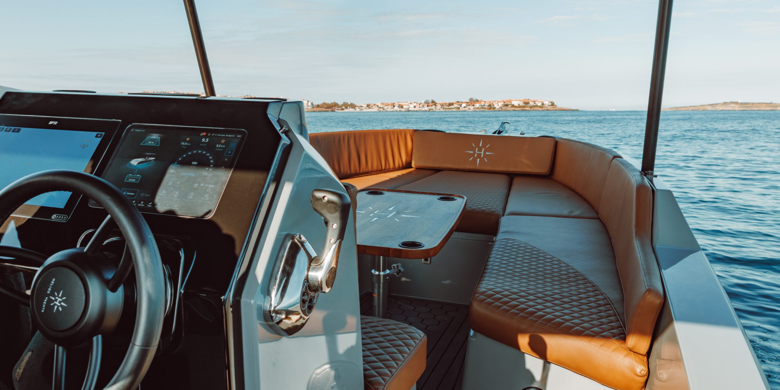 The cockpit and seating area of the Helios Omega 7.2 on the water