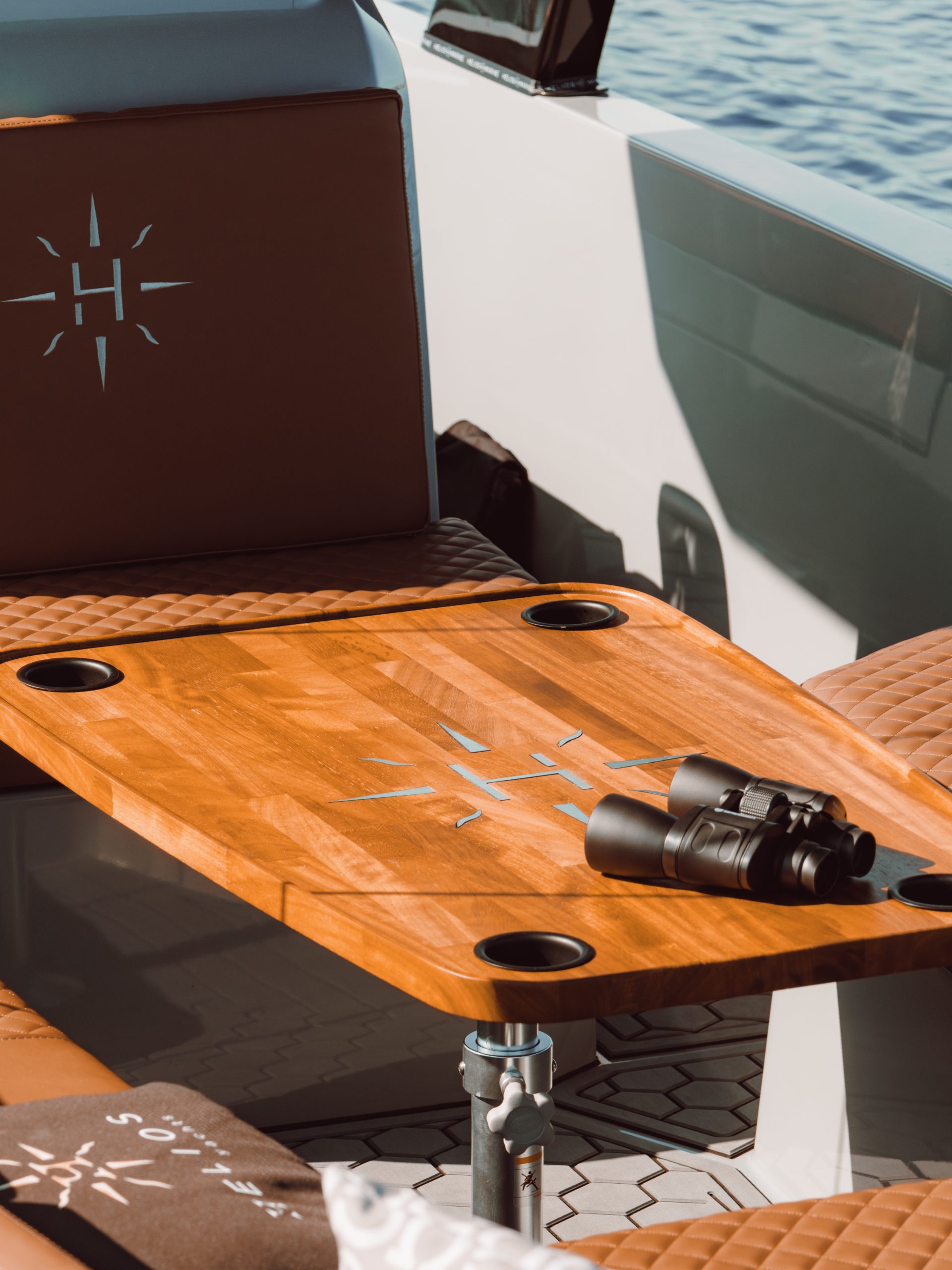 Wooden table and seating area in the Helios Omega 7.2 with binoculars